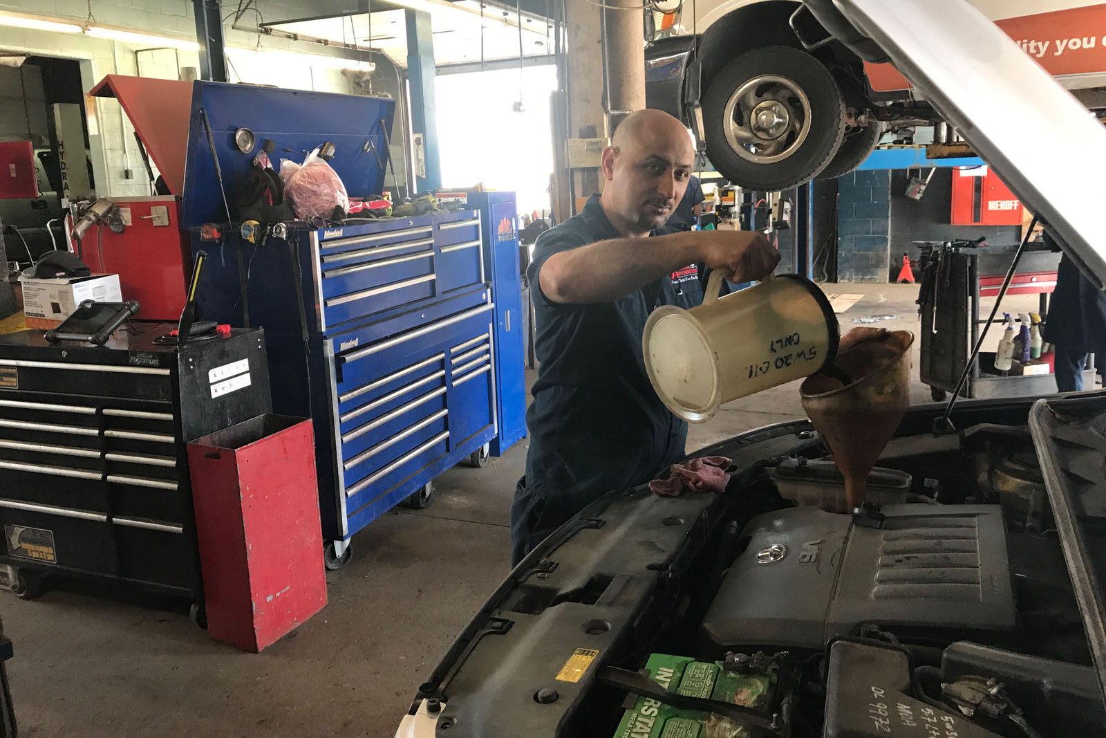 Pouring Oil Into Car